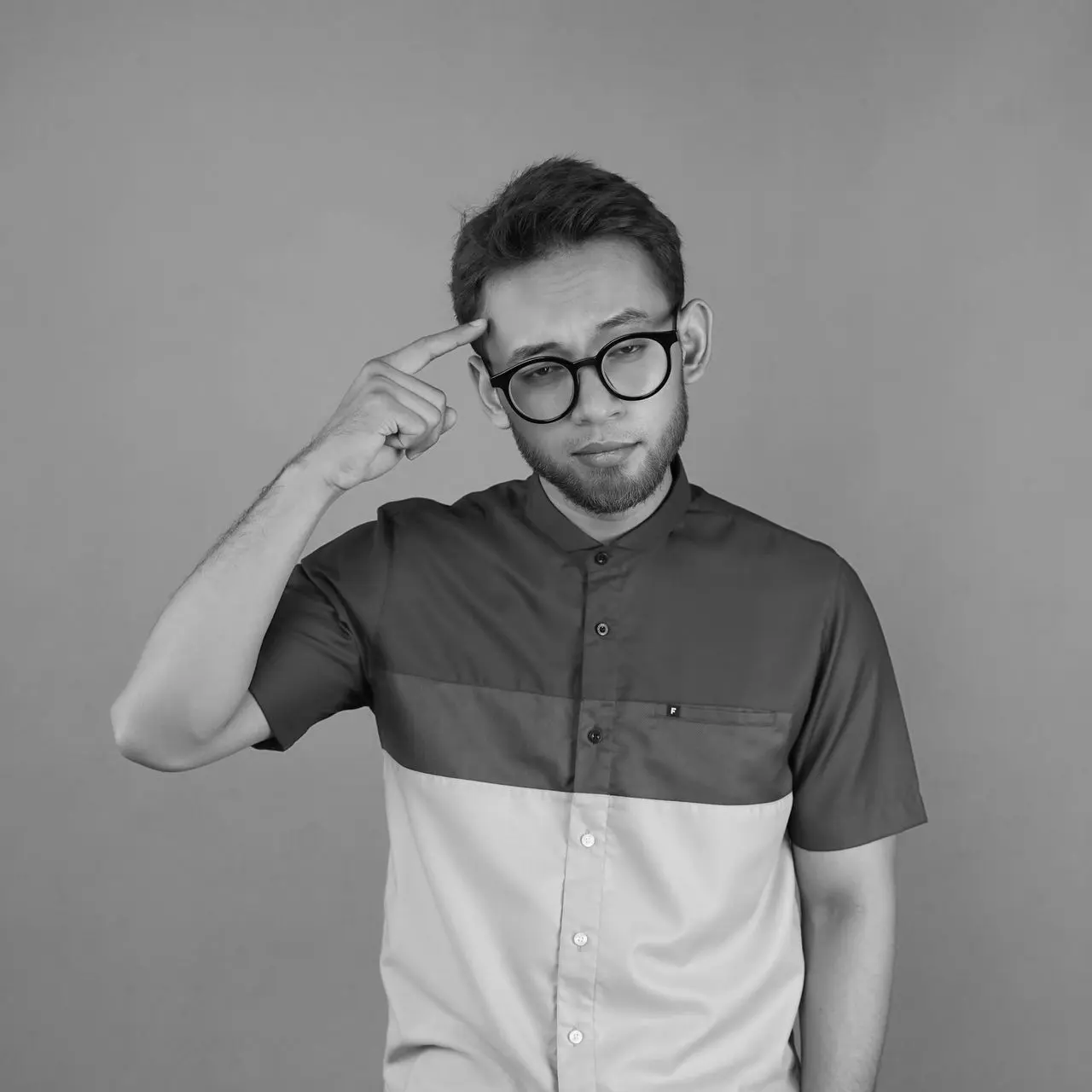 a man with glasses is posing for a picture